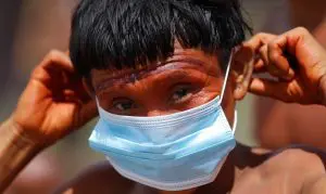 88669972_a-man-from-the-indigenous-yanomami-ethnic-group-holds-his-protective-face-mask-amid-the-spr
